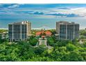 Beautiful aerial view of the luxury beachfront condo buildings surrounded by lush greenery at 1281 Gulf Of Mexico Dr # 906, Longboat Key, FL 34228