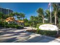 The Water Club entrance with sign and beautiful landscaping welcomes you to a community of luxury and relaxation at 1281 Gulf Of Mexico Dr # 906, Longboat Key, FL 34228