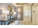 Tastefully decorated hallway with mirror, lamps, decor and elevator access at 1281 Gulf Of Mexico Dr # 906, Longboat Key, FL 34228