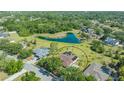 Expansive aerial view of the property, backing onto a serene pond with lush landscaping and mature trees at 13625 3Rd Ne Ave, Bradenton, FL 34212