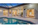 Inviting backyard pool and patio area with comfortable seating and seamless access to indoor living spaces at 13625 3Rd Ne Ave, Bradenton, FL 34212