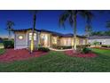 Beautifully landscaped home exterior featuring manicured lawn, mature palms, and inviting front facade at 13625 3Rd Ne Ave, Bradenton, FL 34212