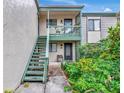 Charming condo entrance with private staircase and well-maintained landscaping at 1532 Pelican Point Dr # 240, Sarasota, FL 34231