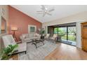 Bright living room featuring vaulted ceiling, natural light, and access to screened lanai at 1532 Pelican Point Dr # 240, Sarasota, FL 34231