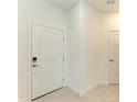Bright entryway featuring a classic white door and neutral tile flooring at 15503 Sunny Day Dr, Bradenton, FL 34211