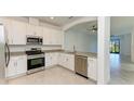 Modern kitchen with white cabinetry, granite countertops, and stainless steel appliances at 15503 Sunny Day Dr, Bradenton, FL 34211