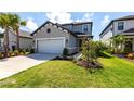 Inviting two-story home with lush green lawn and tidy landscaping at 16134 Paynes Mill Dr, Bradenton, FL 34211