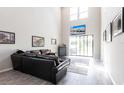 Spacious living room boasting soaring ceilings, gray tile flooring, and abundant natural light at 16134 Paynes Mill Dr, Bradenton, FL 34211