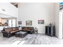 Open-concept living room featuring high ceilings and a view of the kitchen at 16134 Paynes Mill Dr, Bradenton, FL 34211
