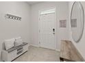 Inviting foyer with a white bench, coat rack, and decorative accents, setting a welcoming tone at 17620 Crescent Moon Loop, Bradenton, FL 34211