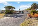 Well-maintained single-story home with a large front yard, mature palm trees, and a double-door entryway at 2105 Georgia Ave, Englewood, FL 34224
