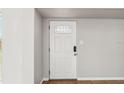 Bright entryway featuring a white door with decorative glass, tile flooring, and neutral wall paint at 2400 Stanford Ave, Bradenton, FL 34207
