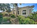 Attractive one-story home with well-maintained landscaping, a tile roof, and lush greenery, providing a welcoming curb appeal at 241 Willow Bend Way, Osprey, FL 34229