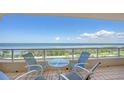 Balcony with seating offers stunning ocean views, perfect for relaxing and enjoying the coastal scenery at 3080 Grand Bay Blvd # 533, Longboat Key, FL 34228
