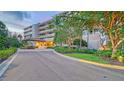 Attractive multi-story building with landscaped entryway and a circular driveway, showcasing curb appeal and architectural design at 3080 Grand Bay Blvd # 533, Longboat Key, FL 34228