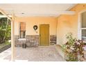 Inviting front porch with brick flooring and stone accents offers a warm welcome to this charming home at 316 29Th W St, Bradenton, FL 34205