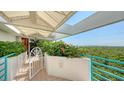 Balcony with tile flooring, railing, colorful flowerbeds, and stunning views of the bay at 340 Gulf Of Mexico Dr # 136, Longboat Key, FL 34228