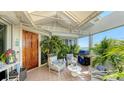 Spacious, covered balcony with outdoor seating, grill, tile floor, and views of the ocean at 340 Gulf Of Mexico Dr # 136, Longboat Key, FL 34228