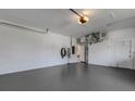 Spacious two car garage features a sealed floor and high ceilings for storage and parking convenience at 4044 Penshurst Park, Sarasota, FL 34235