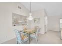 Cozy dining area with a glass-top table, chandelier, and built-in display niche at 4360 Presidential Avenue E Cir, Bradenton, FL 34203