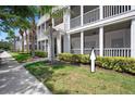 Exterior of condos showing walkway with well manicured shrubs lining the sidewalk on a bright sunny day at 4802 51St W St # 1908, Bradenton, FL 34210