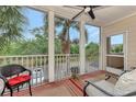 Screened in patio with a cozy sitting area with views of the landscaping and parking area at 4802 51St W St # 704, Bradenton, FL 34210