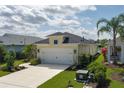 An aerial view of the yellow, single-story home with well-maintained landscaping and lawn at 4839 Deep Creek Ter, Parrish, FL 34219