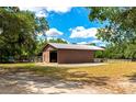 Exterior view of metal barn with drive in access and attached stables at 4876 253Rd E St, Myakka City, FL 34251