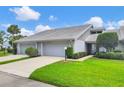 Lovely home with tidy landscaping, featuring mature trees and an attached two-car garage at 5448 Crestlake Blvd # 158, Sarasota, FL 34233