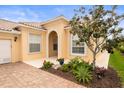 Inviting home with well-kept garden, decorative plants, brick paved entrance, and neutral color scheme at 5751 Wilena Pl, Sarasota, FL 34238