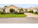 Well-maintained front yard with lush green grass, manicured shrubbery, and a quaint flower tree at 5751 Wilena Pl, Sarasota, FL 34238