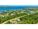 Aerial view of a waterfront community showcasing its desirable location near a beautiful bay and lush greenery at 5826 David Blvd, Port Charlotte, FL 33981