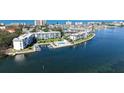 Waterfront condo building with marina, swimming pool, and beautiful landscaping at 600 Sutton Pl # B305, Longboat Key, FL 34228