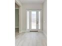 Inviting foyer with light tile flooring and a white door with sidelights, creating a bright, welcoming entrance at 6028 Cat Claw Ln, Bradenton, FL 34210