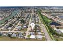 Aerial view of a residential area showcasing a desirable neighborhood with tree-lined streets near a golf course at 609 Glen Oak Rd, Venice, FL 34293