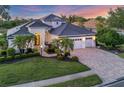 Stunning single-Gathering home featuring a well-manicured lawn and a three-car garage at 7034 Honeysuckle Trl, Lakewood Ranch, FL 34202