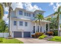 Beautifully designed two-story home with lush landscaping, featuring a welcoming front porch and a two-car garage at 7142 Hawks Harbor Cir, Bradenton, FL 34207