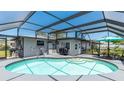 Relaxing screened-in pool area with an in-ground pool, patio furniture, and a well-maintained deck at 959 Cumberland Rd, Venice, FL 34293