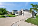 Well maintained exterior with a landscaped front yard, long driveway, and attached two-car garage at 17616 Bright Wheat Dr, Lithia, FL 33547