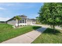 Suburban house featuring a manicured lawn, side driveway, and an attached two-car garage at 17616 Bright Wheat Dr, Lithia, FL 33547