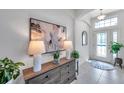 Bright home entry featuring tile floors, arched doorway, and decorative furniture at 17616 Bright Wheat Dr, Lithia, FL 33547