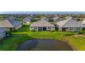 Aerial view of a home with a lush backyard that overlooks a serene pond at 17827 Cherished Loop, Lakewood Ranch, FL 34211