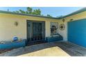 The property's enclosed entrance features a wrought iron gate and stylish door, offering security and curb appeal at 1809 67Th W St, Bradenton, FL 34209