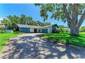 Inviting single-story home featuring an attached garage and lush landscaping, showcasing great curb appeal on a sunny day at 1809 67Th W St, Bradenton, FL 34209