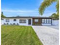 Well-maintained home with vibrant green lawn and freshly painted exterior and manicured landscaping at 1921 Fern Ave, Sarasota, FL 34235