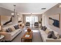 Bright and airy living room featuring neutral decor, plush seating, and access to a balcony for outdoor enjoyment at 2300 Stickney Point Rd # 125, Sarasota, FL 34231
