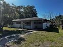 Street view of a single story home with white painted siding and mature trees at 2503 23Rd W Ave, Bradenton, FL 34205