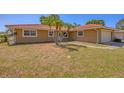 Quaint one-story home with a colorful tile roof, white trim, and freshly cut lawn at 2536 Carlisle Pl, Sarasota, FL 34231