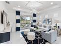 Bright living room features white walls, white tile floors, modern lighting, and stylish decor at 256 Van Gogh Cv, Bradenton, FL 34212