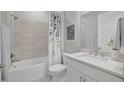 Clean bathroom with white vanity, matching toilet, and a shower-tub combination at 27061 Paradise Shores Dr, Englewood, FL 34223